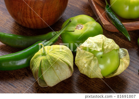 Tomatillos, green tomatoes, and chili peppers. Mexican cuisine ingredients Tomatillos, green tomatoes, and chili peppers. Mexican cuisine ingredients 81691807