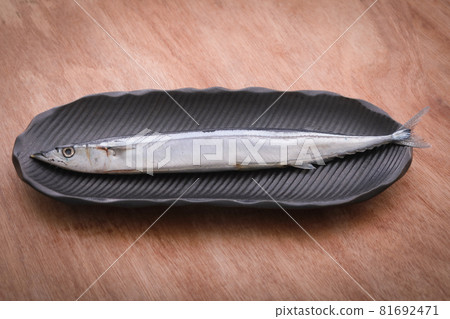 Whole raw pacific saury fish on a black plate Whole raw pacific saury fish on a black plate 81692471