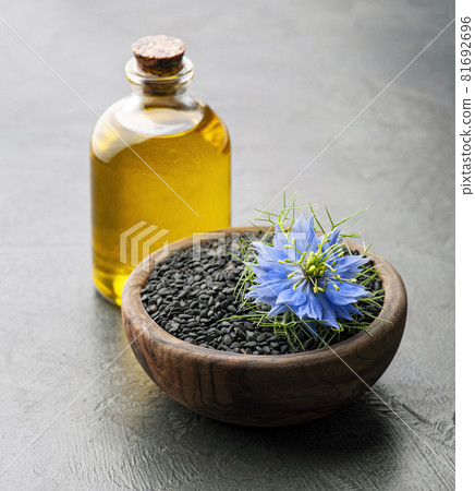 Cumin seed oil with flowers Cumin seed oil with flowers 81692696