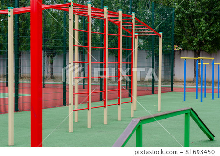 Sports ground with a variety of horizontal bars. Open area for sports in the city park. Horizontal and vertical bars. Sports, active lifestyles. No people. Selective focus. Sports ground with a variety of horizontal bars. Open area for sports in the city park. Horizontal and vertical bars. Sports, active lifestyles. No people. Selective focus. 81693450