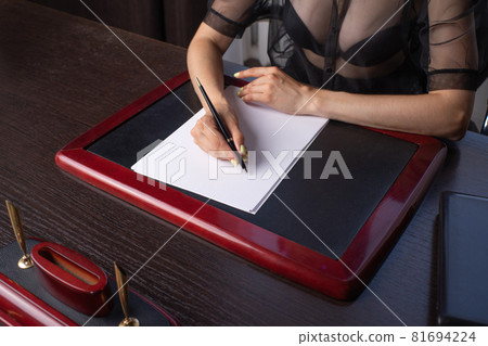 Close-up Of Businesswoman's Hand Signing On Papers Over Desk 81694224