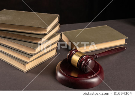 Judges gavel on legal document with law books on 81694304