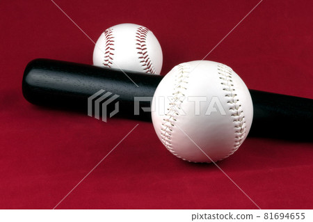 Black Baseball Bat with Senior and Junior Softballs on a Red Background Black Baseball Bat with Senior and Junior Softballs on a Red Background 81694655