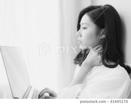 Young Asian woman feeling shoulder pain while using laptop Young Asian woman feeling shoulder pain while using laptop 81695278