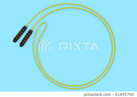 Yellow skipping rope or jumping rope isolated on blue background. Yellow skipping rope or jumping rope isolated on blue background. 81695700