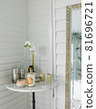 Candles and orchid flowers on the table near mirror in bathroom 81696721