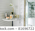Candles and orchid flowers on the table near mirror in bathroom 81696722