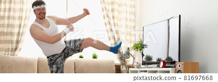 Fat man in sportswear and dumbbells does physical exercise 81697668