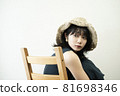 Portrait of a woman wearing a straw hat 81698346