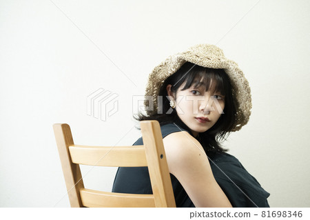 Portrait of a woman wearing a straw hat Portrait of a woman wearing a straw hat 81698346
