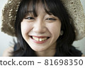 Portrait of a woman wearing a straw hat 81698350