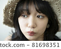 Portrait of a woman wearing a straw hat 81698351