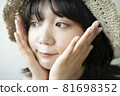 Portrait of a woman wearing a straw hat 81698352