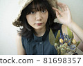 Portrait of a woman wearing a straw hat 81698357