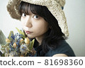 Portrait of a woman wearing a straw hat 81698360