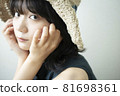 Portrait of a woman wearing a straw hat 81698361