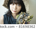Portrait of a woman wearing a straw hat 81698362