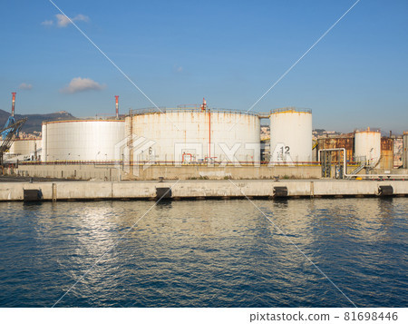 big oil tanks  in petrochemical port, reflecting in the water 81698446