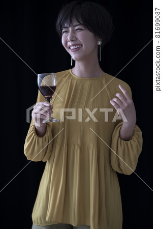 A woman with a wine glass A woman with a wine glass 81699087