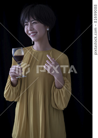 A woman with a wine glass A woman with a wine glass 81699088