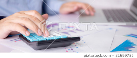Hands of businessman calculate tax with calculator while laptop computer on desk. Hands of businessman calculate tax with calculator while laptop computer on desk. 81699785