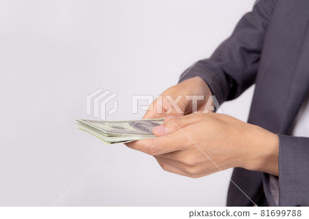 Hand of business man giving money isolated on white background, finance and cash. 81699788