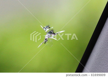 Scratches (cracks) created by stepping stones hitting the windshield of a car Scratches (cracks) created by stepping stones hitting the windshield of a car 81699809