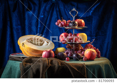 Still life with melon and fruit on a dark blue background. Still life with melon and fruit on a dark blue background. 81700093