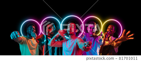 Collage made of multiethnic young people standing together isolated on dark studio background in multicolored neon light with geometric luminescent shape cirlce 81701011