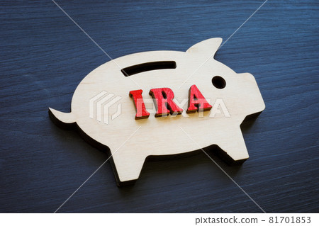 Wooden piggy bank and IRA individual retirement account abbreviation. Wooden piggy bank and IRA individual retirement account abbreviation. 81701853