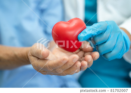 Doctor give red heart to Asian senior or elderly old lady woman patient, healthy strong medical concept Doctor give red heart to Asian senior or elderly old lady woman patient, healthy strong medical concept 81702007
