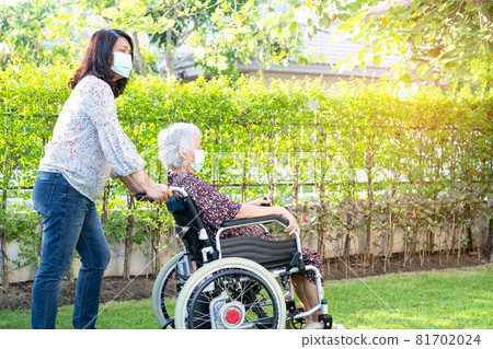 Doctor help and care Asian senior or elderly old lady woman patient sitting on wheelchair at park in nursing hospital ward, healthy strong medical concept. 81702024