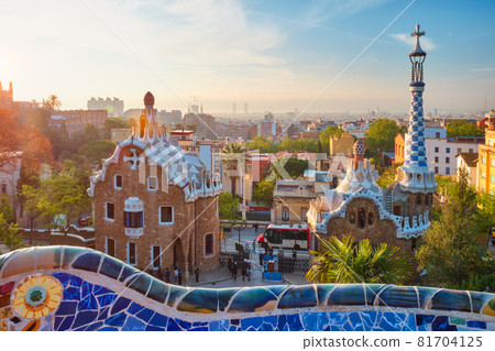 Barcelona city view from Guell Park. Sunrise view of colorful mosaic building in Park Guell Barcelona city view from Guell Park. Sunrise view of colorful mosaic building in Park Guell 81704125