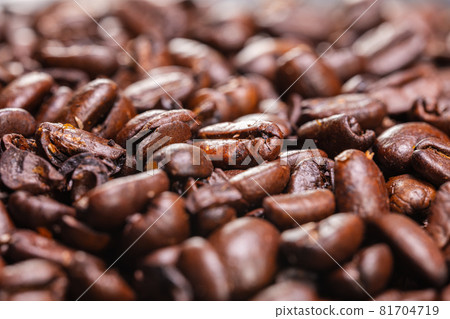 Close up to a heap of coffee beans. Macro photography of fresh roasted coffee beans high resolution. Detailed macro picture on roasted coffee beans.  Close-up of brown coffee beans background  image 81704719