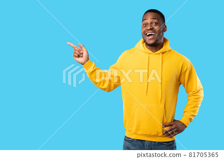 Black Man Pointing Fingers Aside Showing Empty Space, Blue Background 81705365