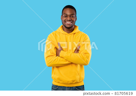 Happy African American Man Posing Crossing Hands On Blue Background 81705619