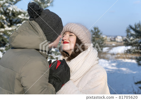 Portrait of happy loving couple in winter forest. Tenderness and love 81705620
