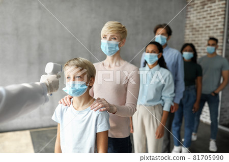 Multiracial group of people in face masks checking body temperature Multiracial group of people in face masks checking body temperature 81705990