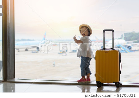 Baby looking at the plane in airport 81706321