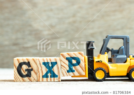 Toy forklift hold letter block P to complete word GXP on wood background Toy forklift hold letter block P to complete word GXP on wood background 81706384