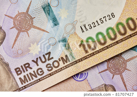 Macro shot of uzbek sum banknote. Pile of Uzbek sums. Uzbek currency money bill. A stack of one hundred thousand Uzbek sum. 100000 sum 81707427