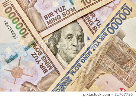 US dollar banknote and Uzbek sums. Concept of exchange rate, Uzbek sum to us dollar. Money exchange in Uzbekistan. Pile of Uzbek money sum and American dollar bill US dollar banknote and Uzbek sums. Concept of exchange rate, Uzbek sum to us dollar. Money exchange in Uzbekistan. Pile of Uzbek money sum and American dollar bill 81707786