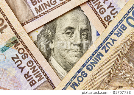 US dollar banknote and Uzbek sums. Concept of exchange rate, Uzbek sum to us dollar. Money exchange in Uzbekistan. Pile of Uzbek money sum and American dollar bill 81707788