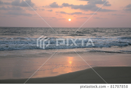 Pink sunset on Varca beach in South Goa in India 81707858
