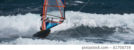 Windsurfer surfing the wind on waves in ocean sea 81708739