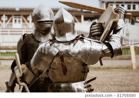Reenactment of battle with medieval knights in heavy armor on tournament Reenactment of battle with medieval knights in heavy armor on tournament 81708880
