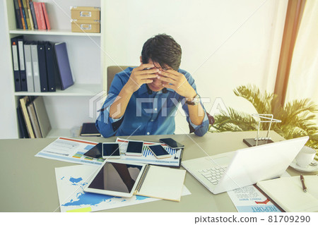 businessman who looks busy negotiating through multiple mobile phones. During the coronavirus disease 2019 epidemic around the world. Working from home businessman who looks busy negotiating through multiple mobile phones. During the coronavirus disease 2019 epidemic around the world. Working from home 81709290