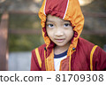 cute boy in red and yellow jacket in winter 81709308
