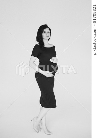 happy pregnant mother touching her belly and 81709821