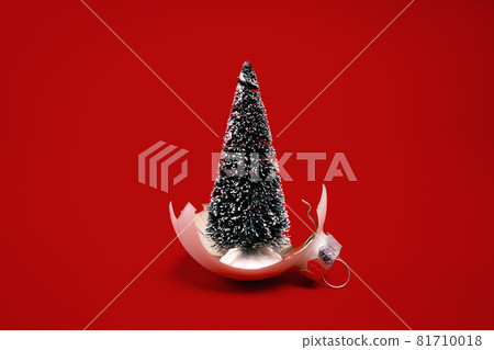 White broken glass bauble on red Christmas background. White broken glass bauble on red Christmas background. 81710018